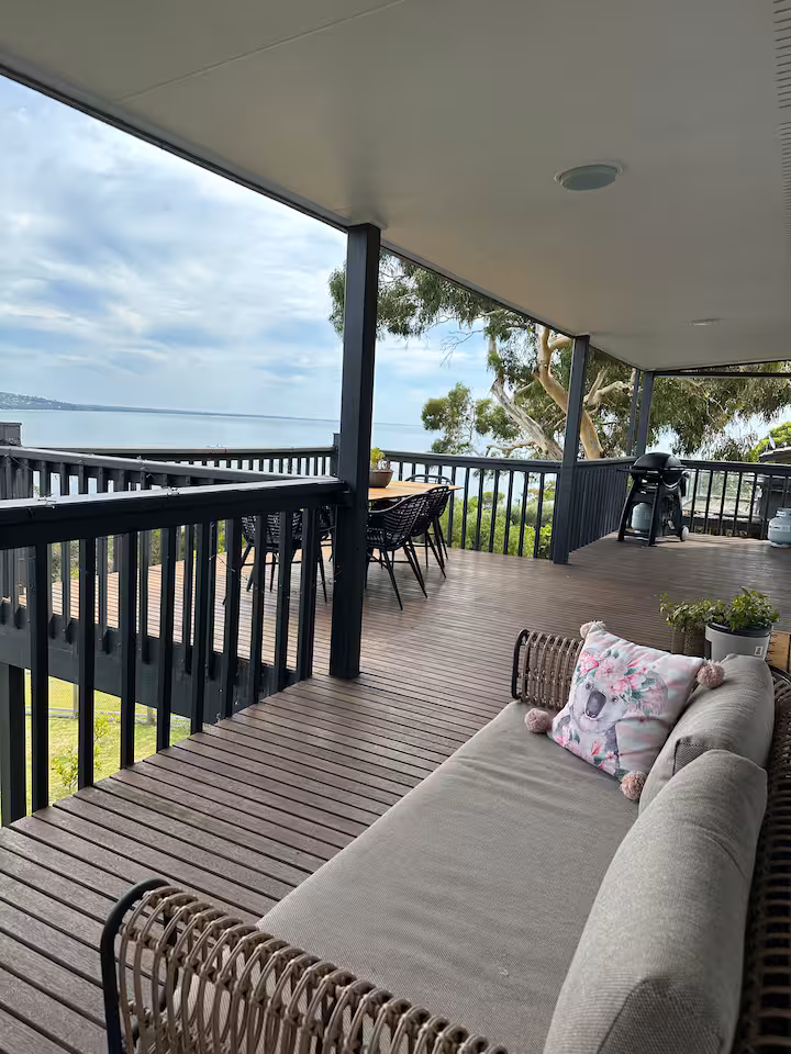 Covered deck with lounge, dining setting and barbecue