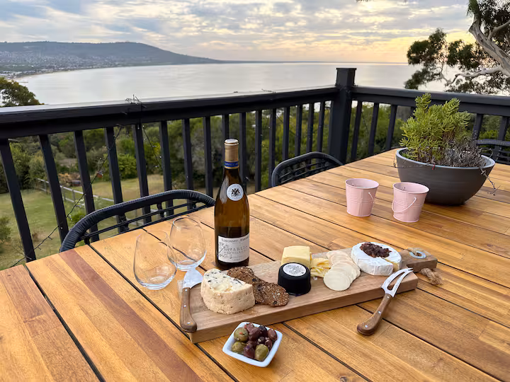 Cheese board and wine on the deck overlooking the bay