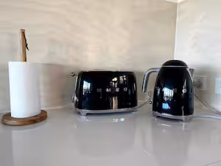 Kitchen bench with black Smeg toaster and kettle