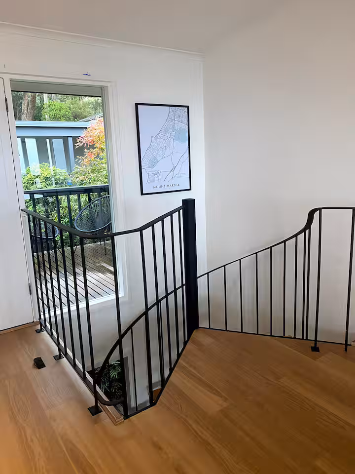 Upper landing at Mar Vista with wrought-iron balustrade and Mount Martha map print